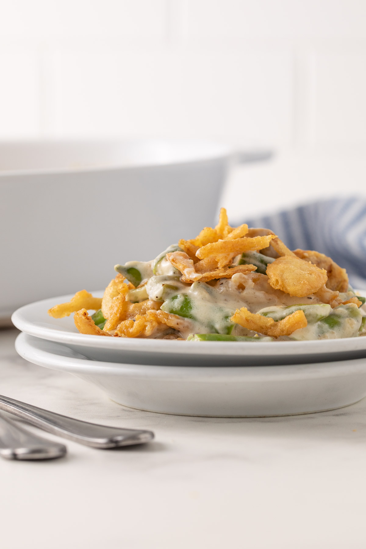 Front view of green bean casserole on a small round white plate.