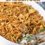 Casserole in a dish with a spoon with overlay text that reads, "green bean casserole".