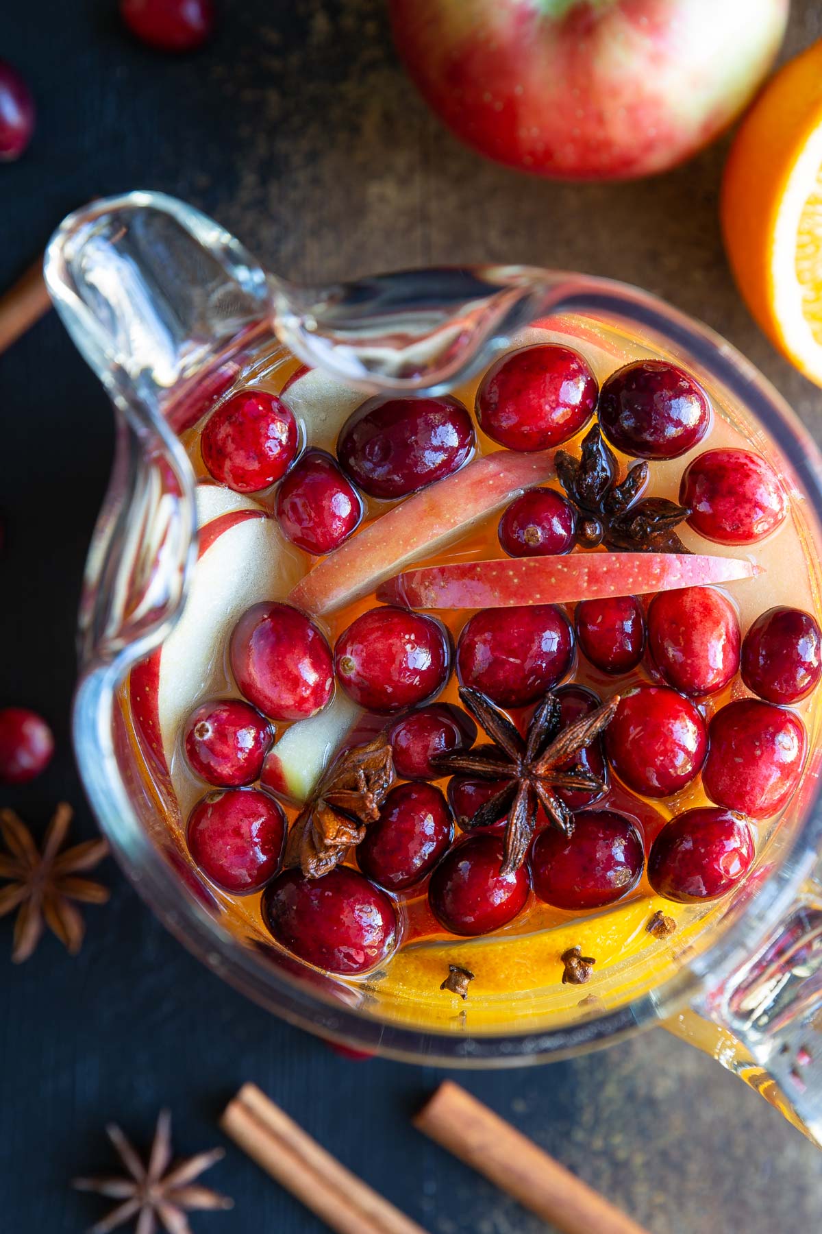 Overhead view of a pitcher of Thanksgiving sangria with fruit and star anise.