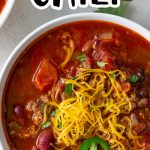 Overhead closeup of a bowl of chili with overlay text.