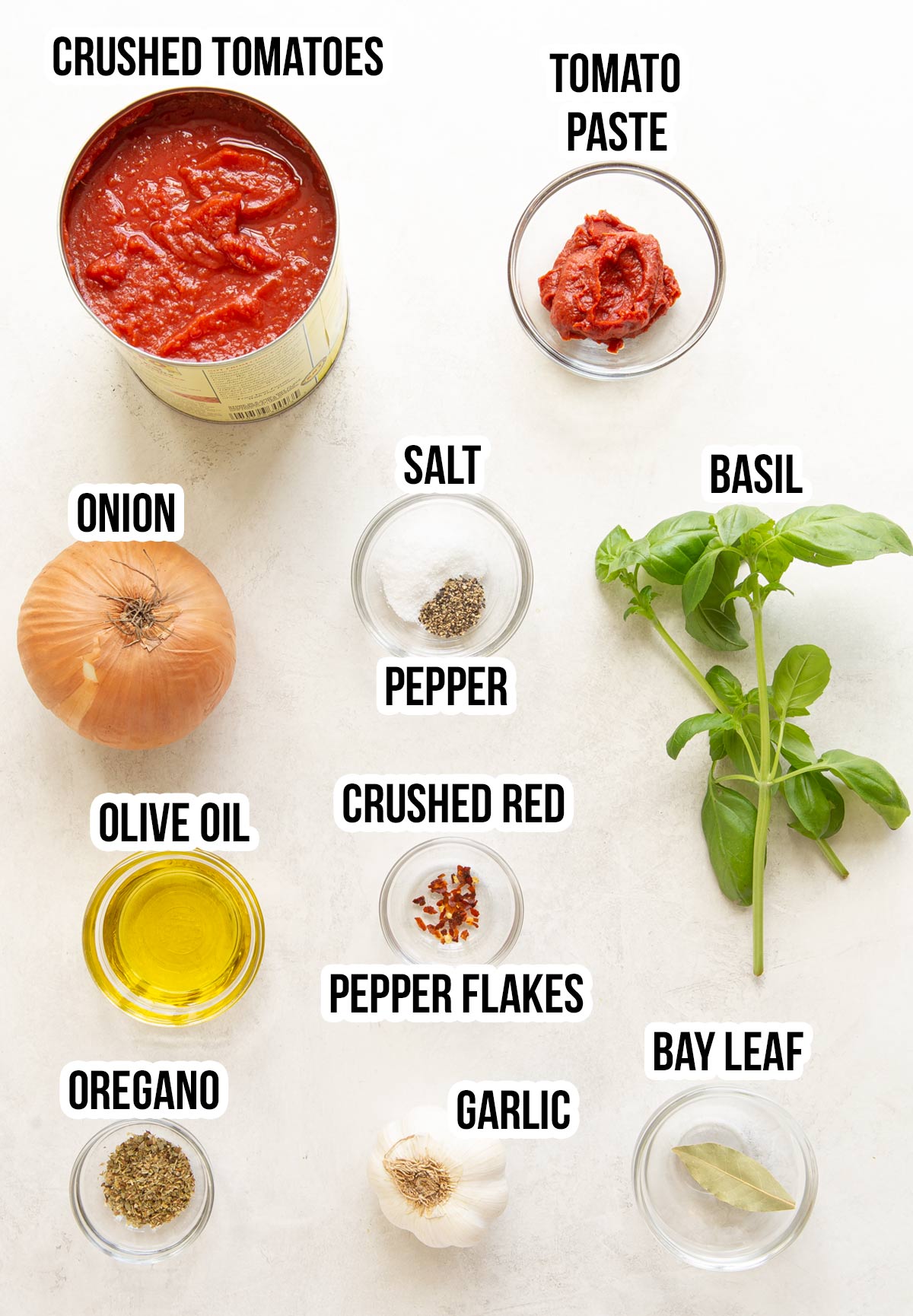 Overhead view of ingredients for marinara sauce with overlay text.