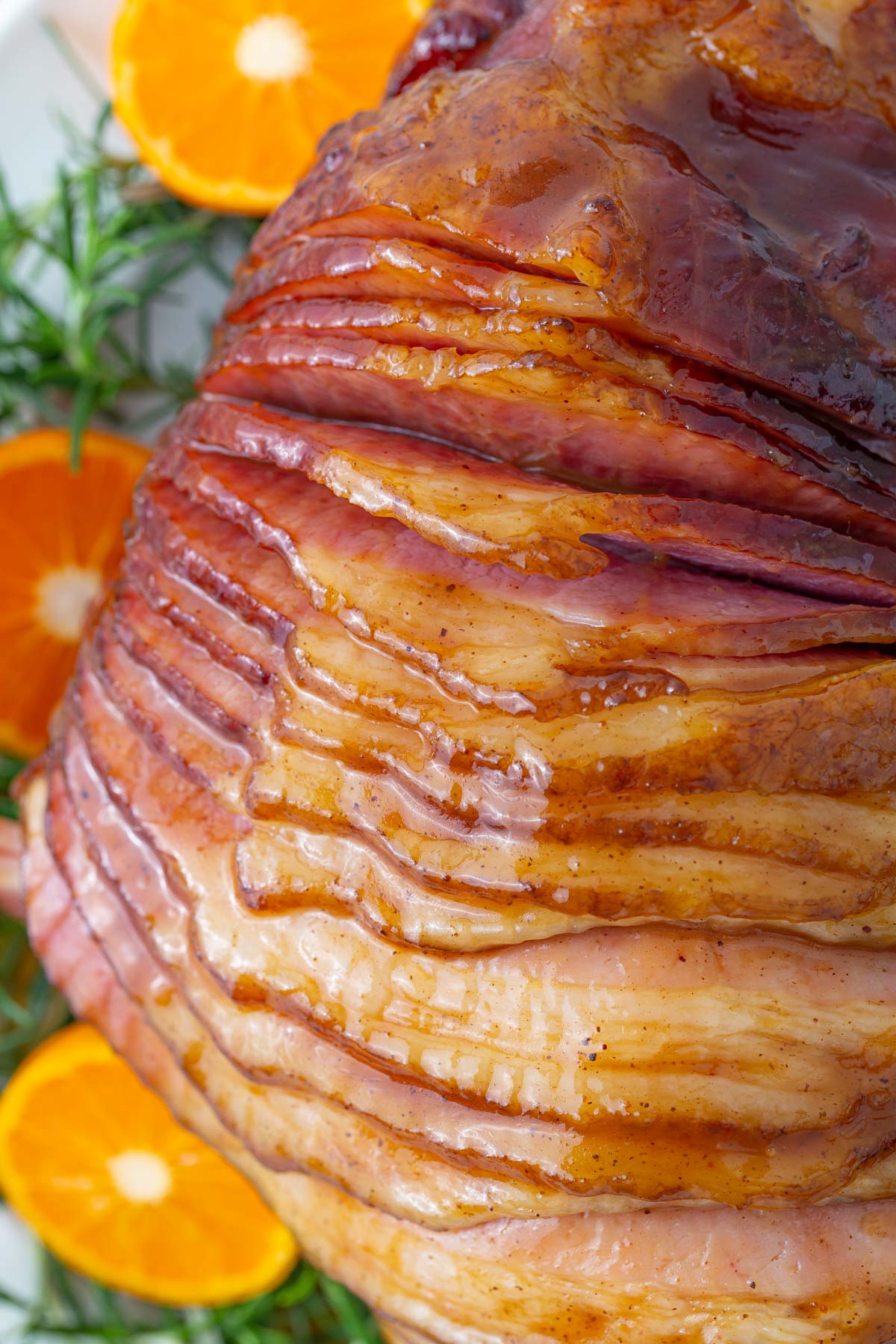 Overhead closeup view of a glazed spiral ham on a platter.