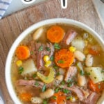 Overhead view of a bowl of ham bone soup with overlay text.