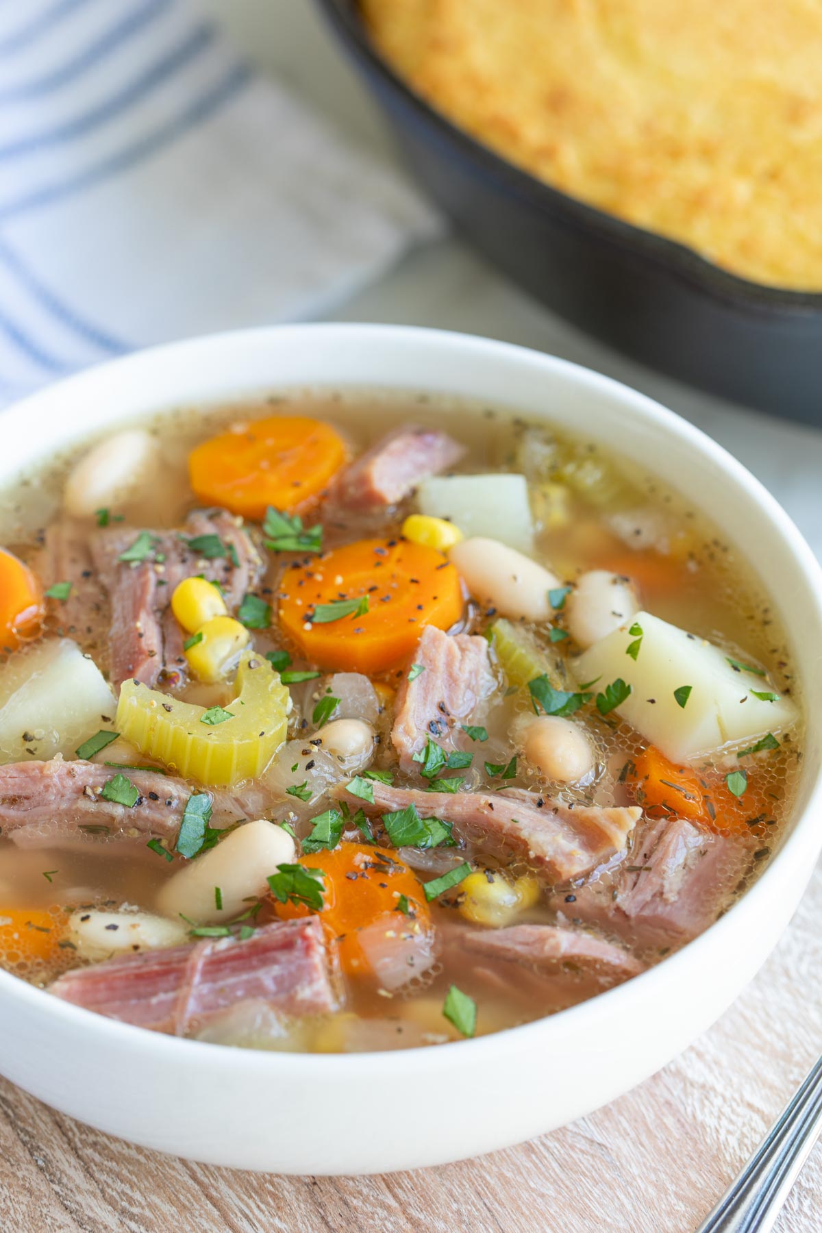 Closeup view of a bowl of ham and white bean soup.