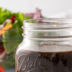 A jar of balsamic vinaigrette dressing. Overlay text at top of image.