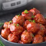 A bowl of cranberry meatballs. Overlay text at top of image.