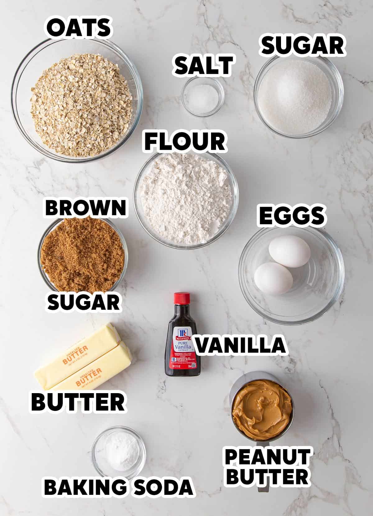 Overhead view of ingredients for oatmeal peanut butter cookies with overlay text.