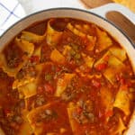 Lasagna soup in a Dutch oven. Overlay text at top of image.