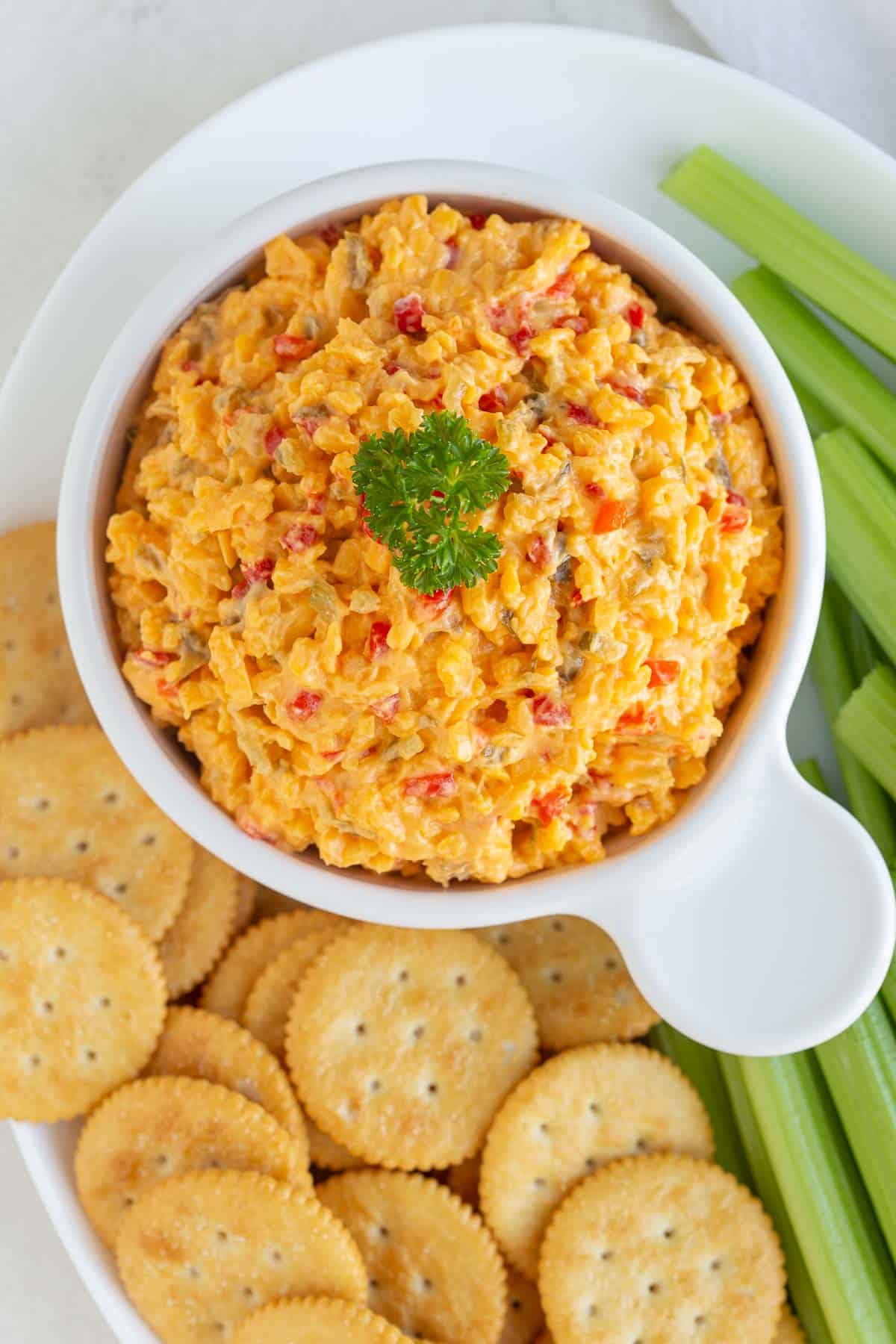 Overhead close up view of a bowl of pimento cheese spread.