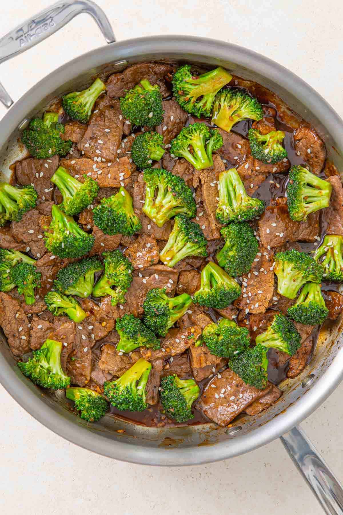 Overhead view of beef and broccoli in a sauté pan.