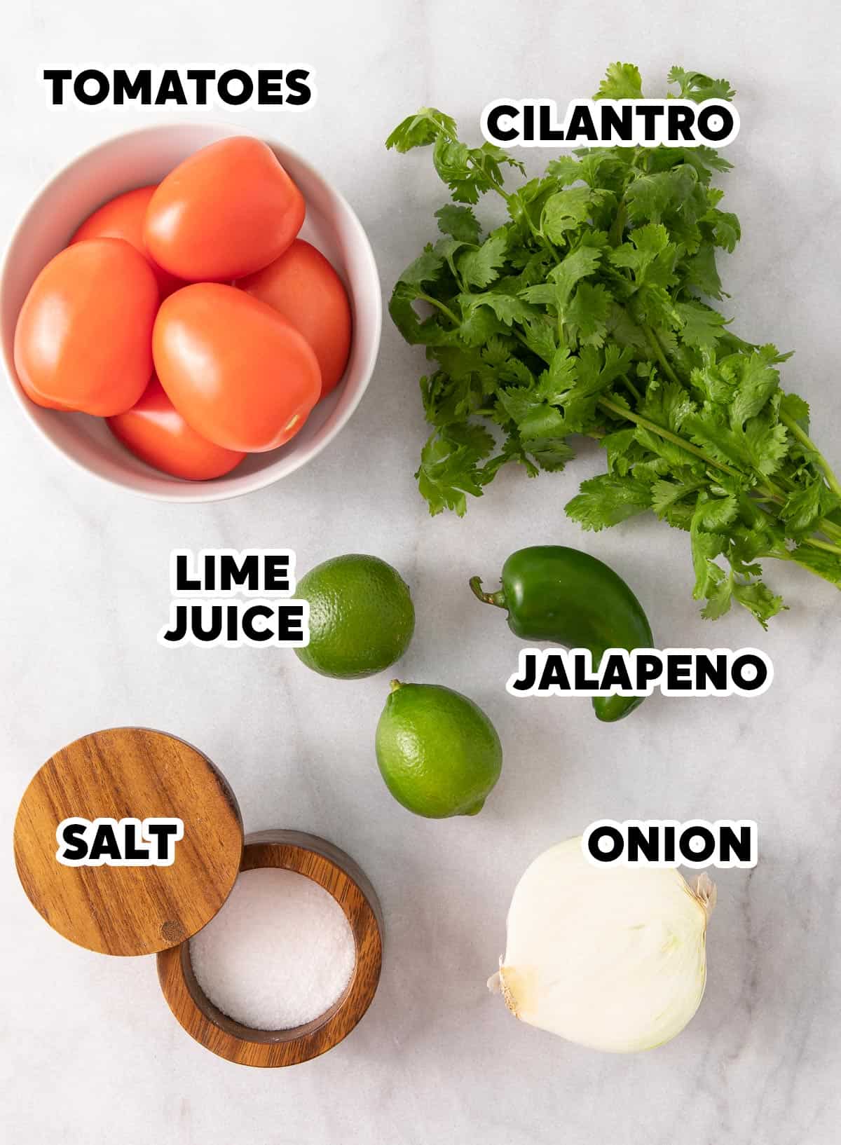 Overhead view of ingredients for Pico de Gallo on a marble surface with overlay text.