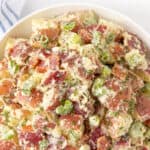 Overhead closeup view of a bowl of red potato salad. Overlay text at top of image.