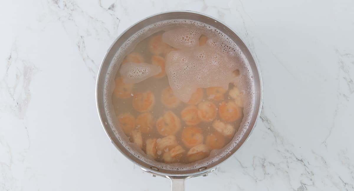 A pot of shrimp that have just been boiled to be used in shrimp salad.
