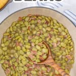 Butter beans in a Dutch oven with a wooden ladle. Overlay text at top of image.