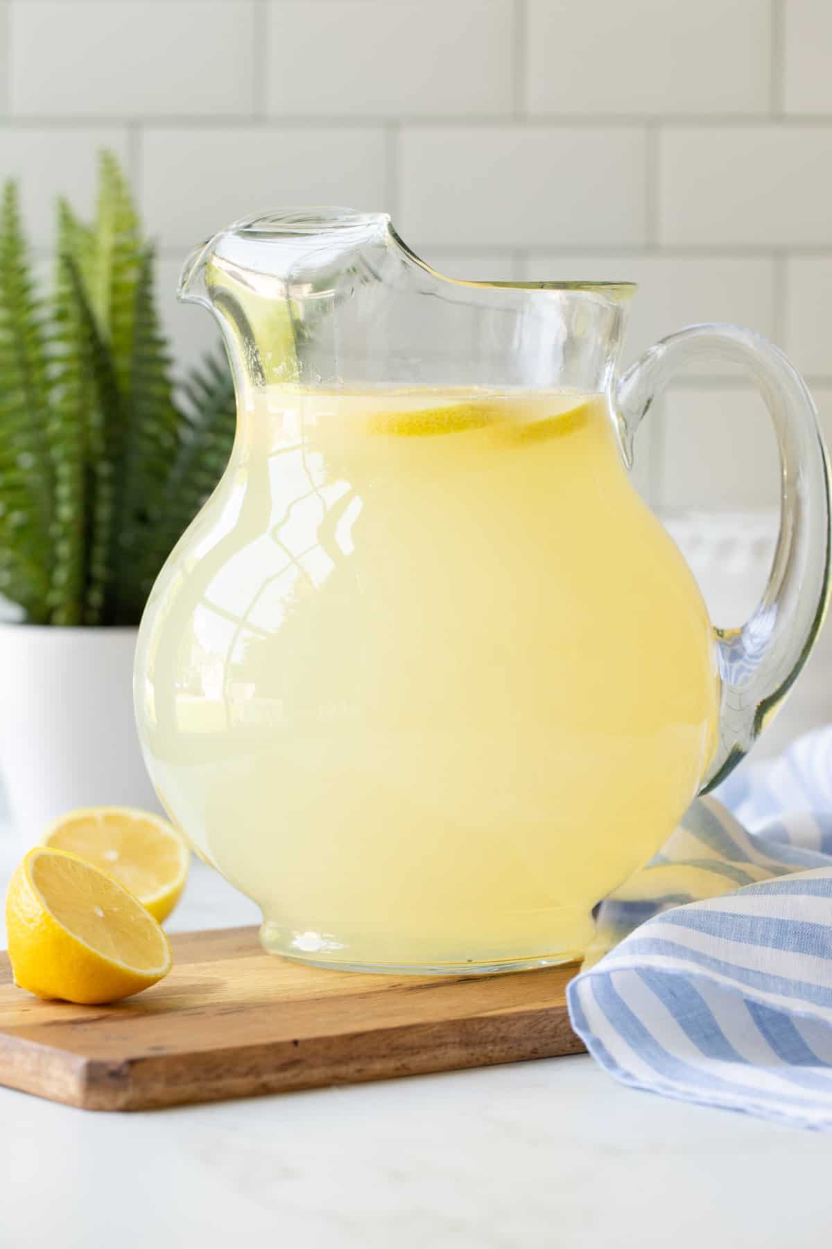 Front view of a glass pitcher of homemade lemonade.