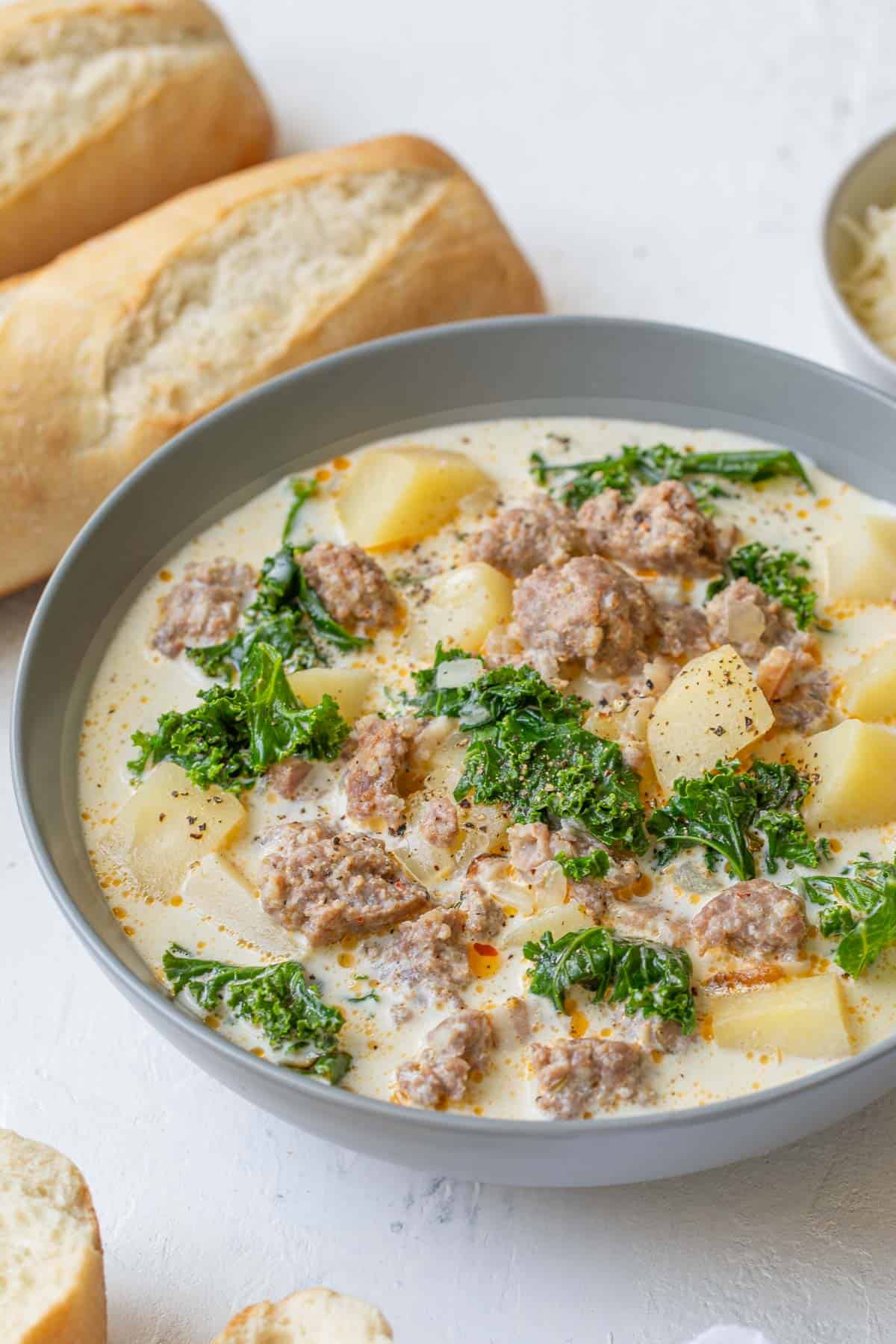 Front angled view of a bowl of slow cooker Zuppa Toscana soup.