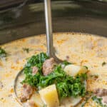 Close-up of a ladle in a crock pot of Zuppa Toscana soup. Overlay text is at the top of the image.