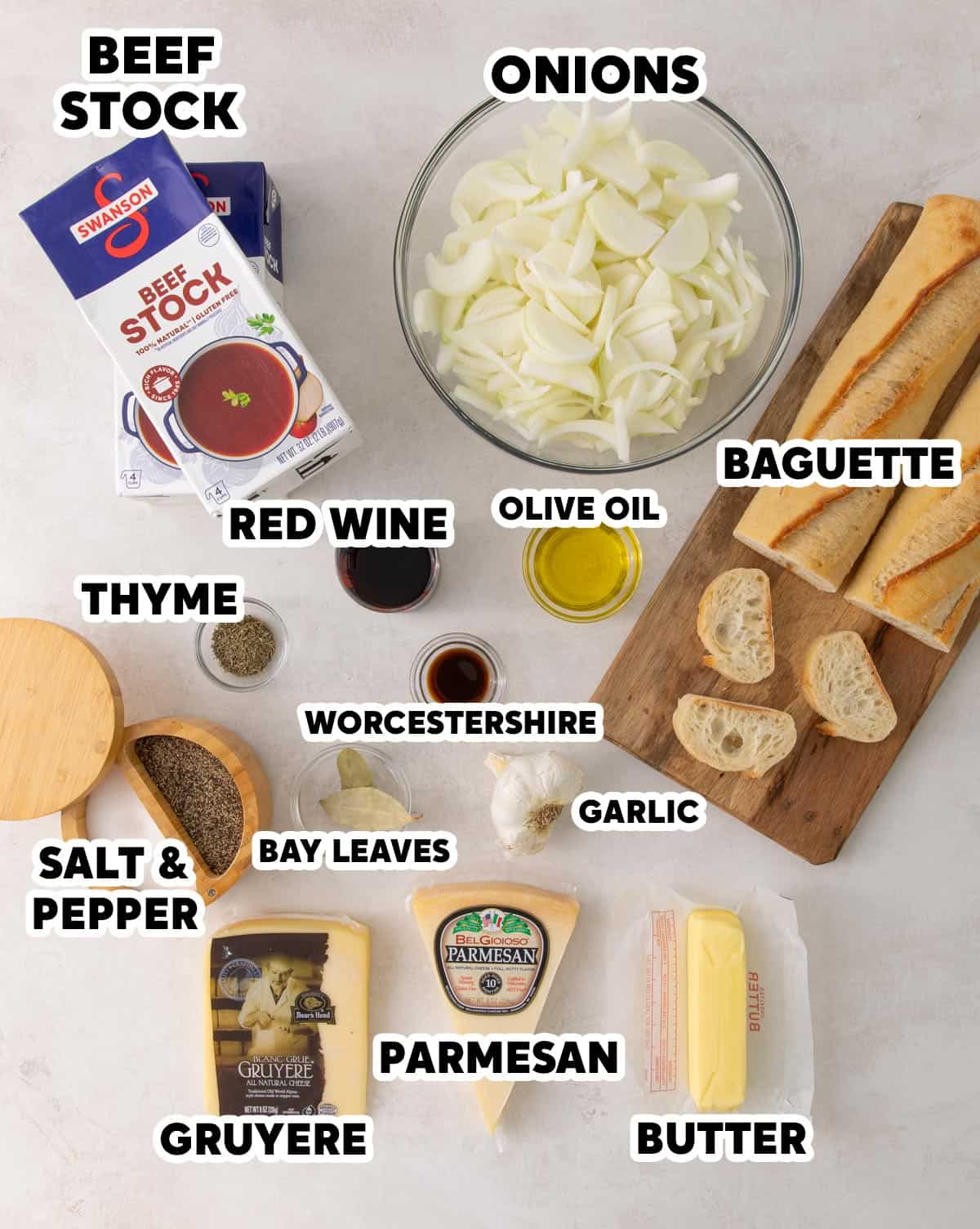 Overhead view of ingredients for making French onion soup with overlay text.