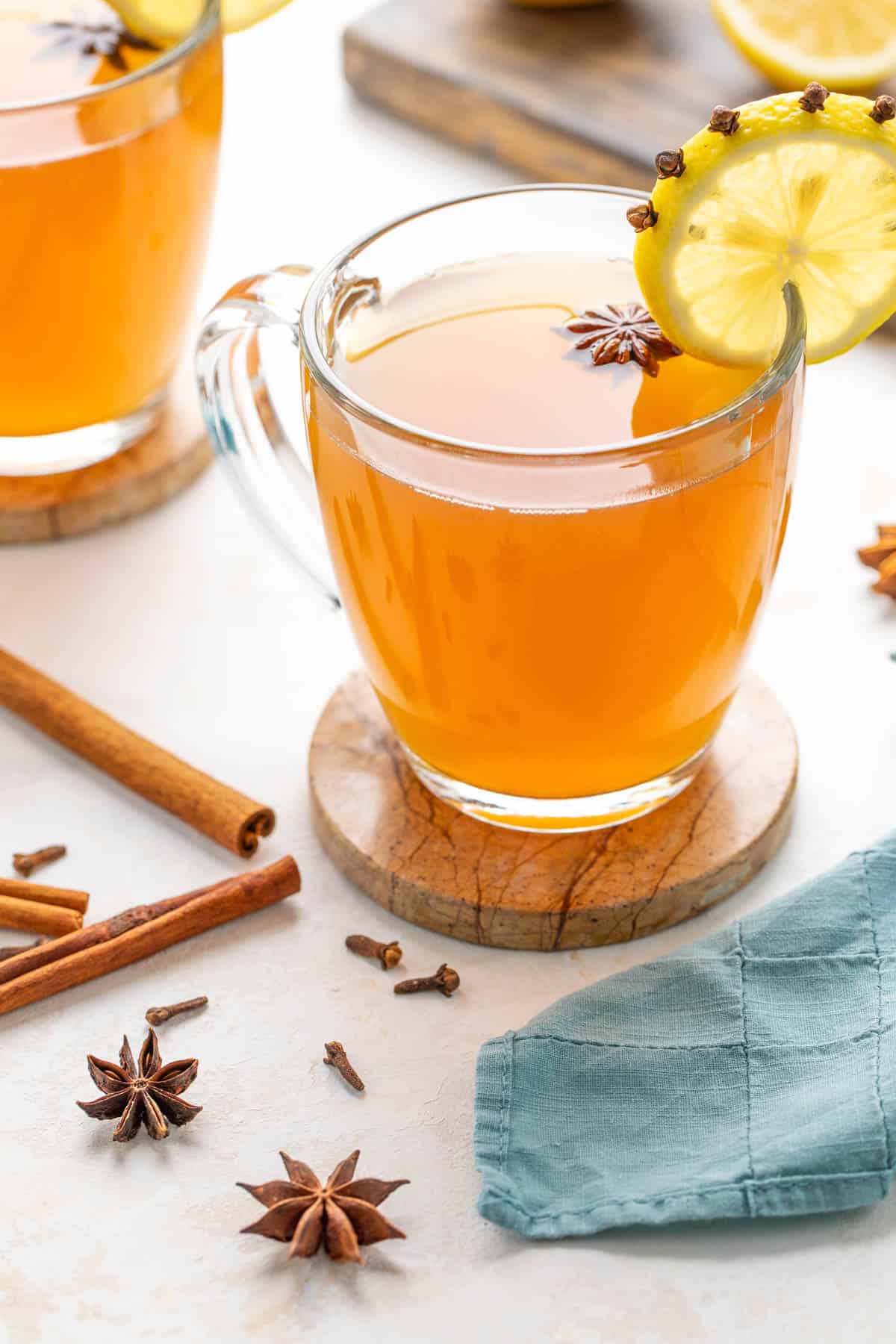 A hot toddy drink garnished with lemon and star anise.