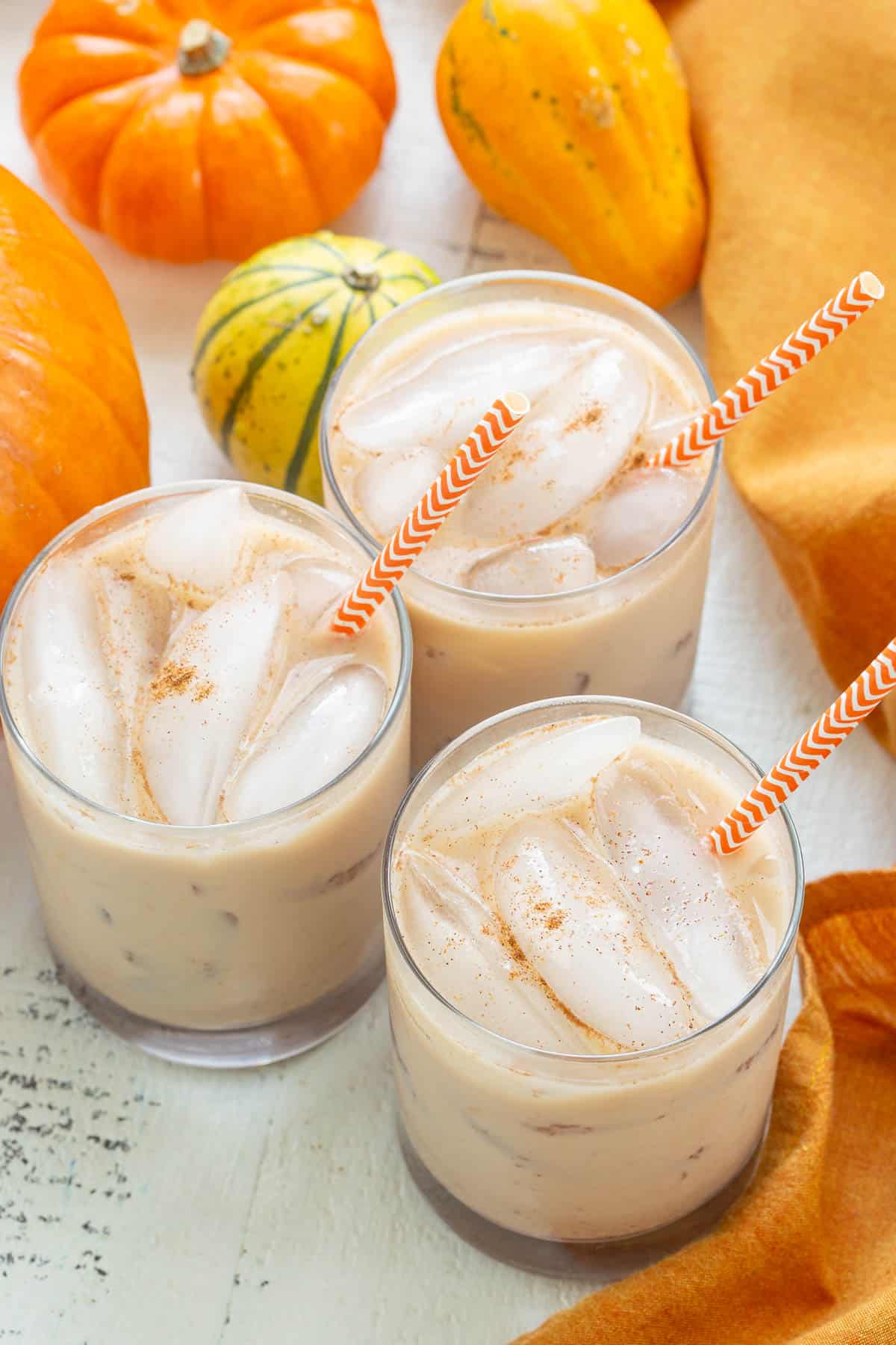 Overhead view of three pumpkin spice white Russian cocktails.