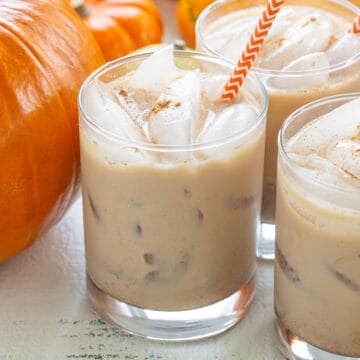 Front close-up view of three pumpkin spice white Russians.