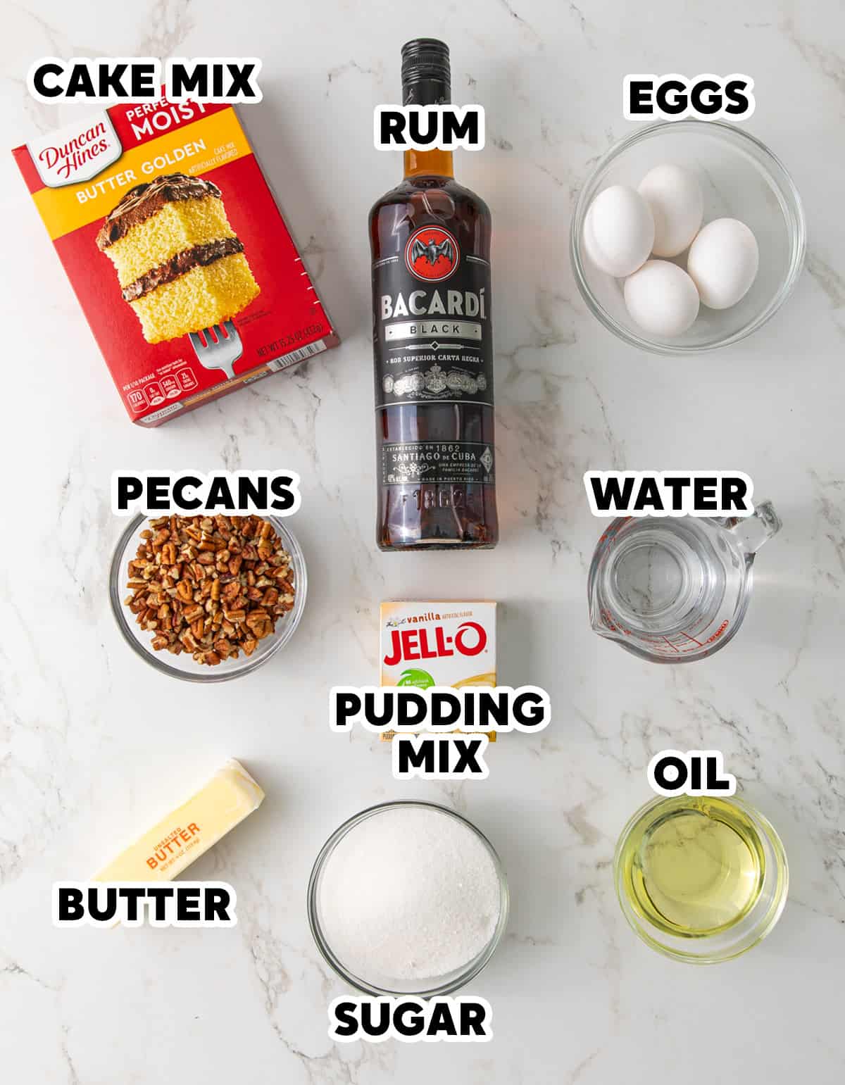 Overhead view of ingredients for making a Bacardi rum cake with overlay text.