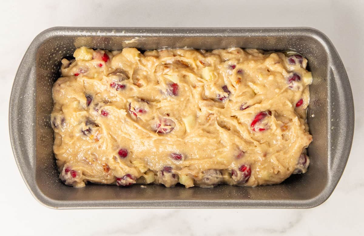 Cranberry apple bread batter in a loaf pan.