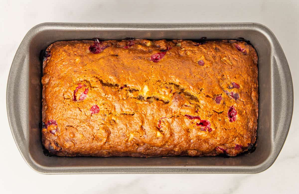 Baked cranberry apple bread in a loaf pan.