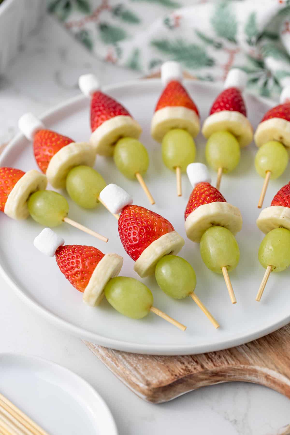 Front angled view of Grinch kabobs on a white plate.