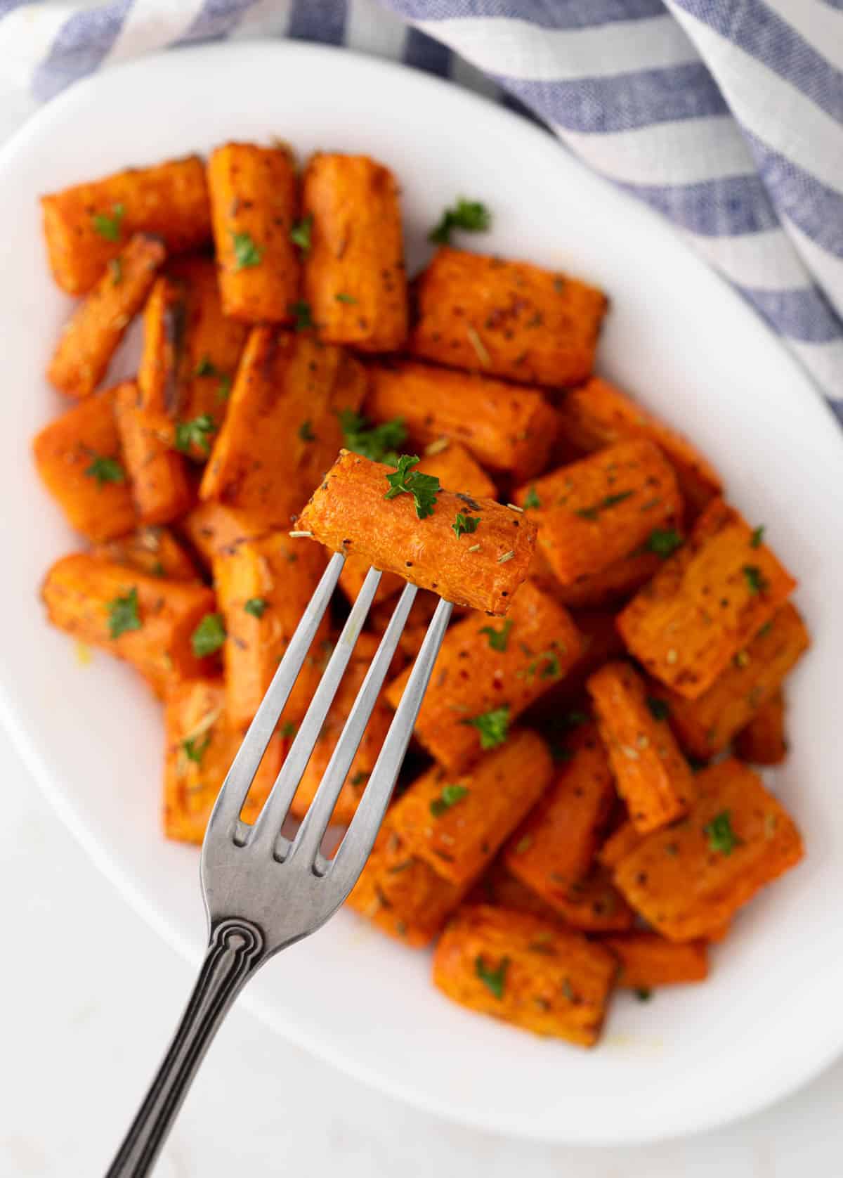 Overhead close up of a fork piercing an air fried carrot.